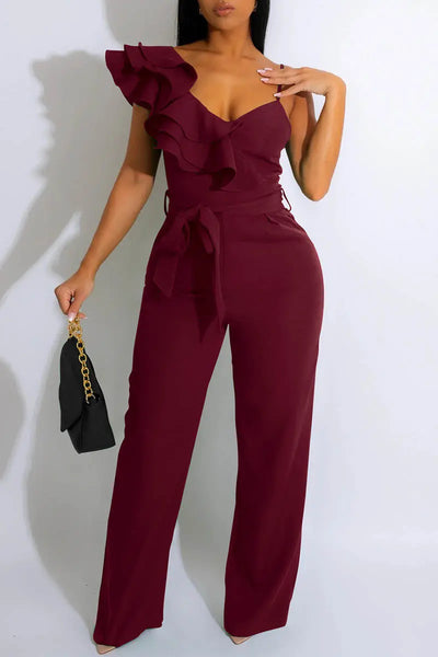 Hoochie Couture V-Neck Patchwork Jumpsuit – edgy and figure-flattering women’s one-piece featuring a deep V-neckline, bold colorblock patchwork design, and bodycon fit, perfect for street style, nightlife, or fashion-forward daywear.