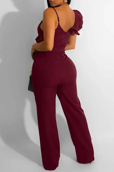 Hoochie Couture V-Neck Patchwork Jumpsuit – edgy and figure-flattering women’s one-piece featuring a deep V-neckline, bold colorblock patchwork design, and bodycon fit, perfect for street style, nightlife, or fashion-forward daywear.